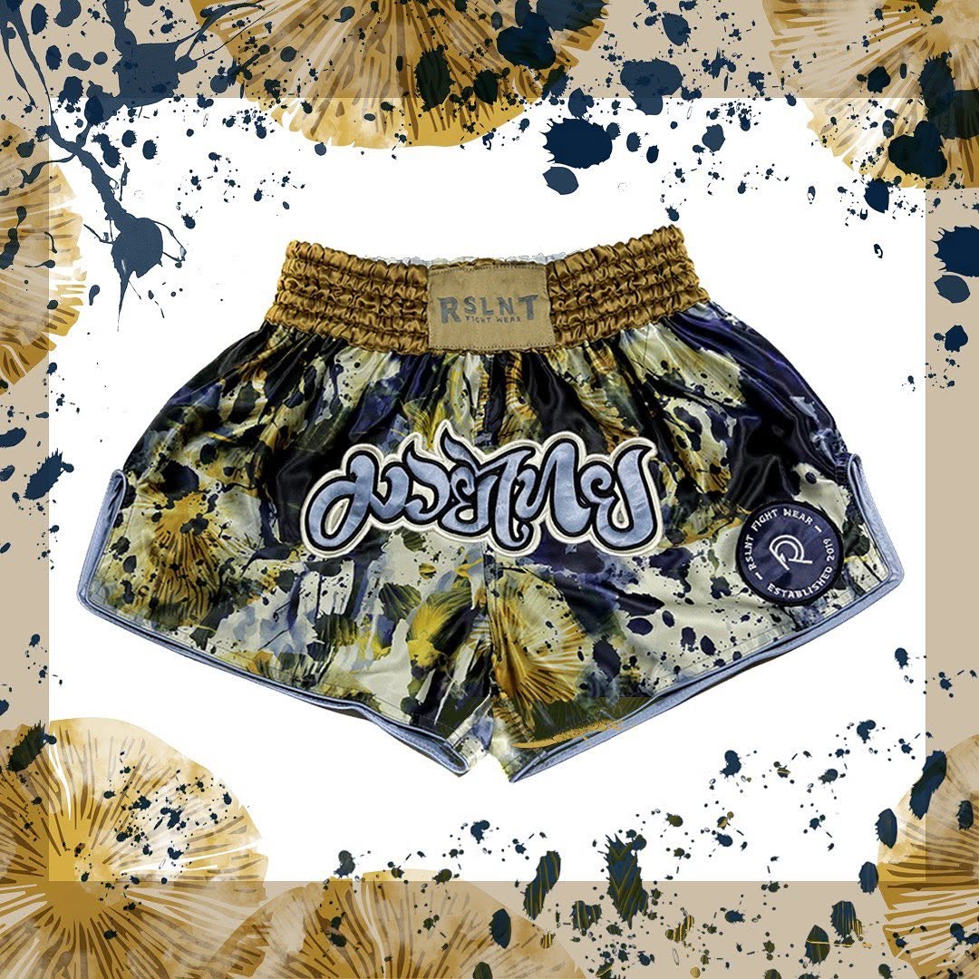 Illustrated RSLNT Muay Thai shorts presented as a product showcase.